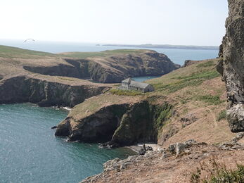 An island coastline with brown vegetation.