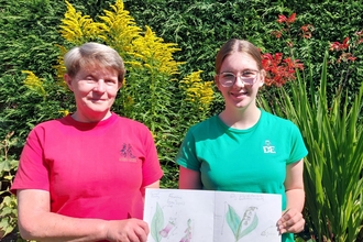 Pauline and Ffion with her notebook of nature art