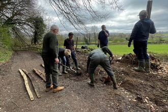 A group of people fixing a fence