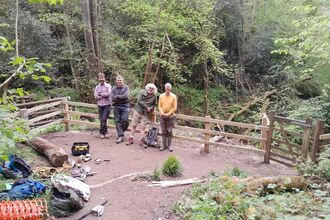 A group of people stood in front of a new wooden fence
