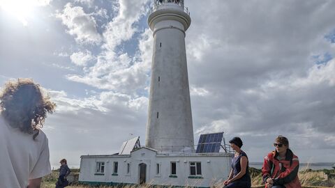 Visitors to Flat Holm Island in front of the lighthouse