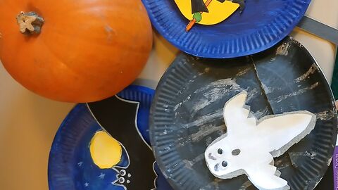 paper plates painted with halloween scenes