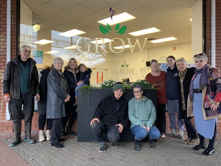 A group of women outside GROW's building. 