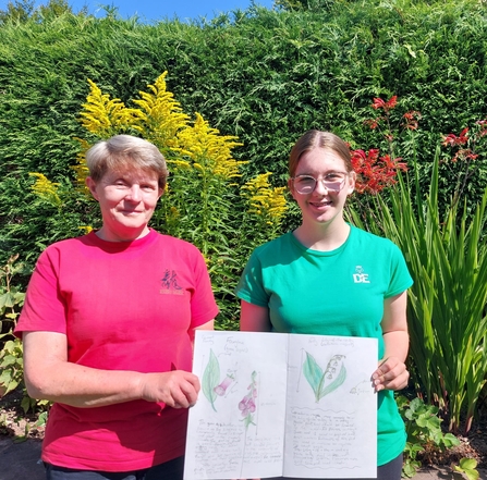 Pauline and Ffion with her notebook of nature art