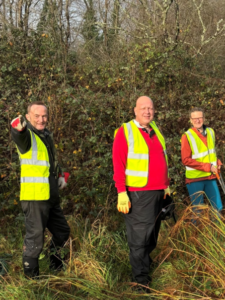 Three members of Pencoed Trailblazers in Hi-Vis clearing paths