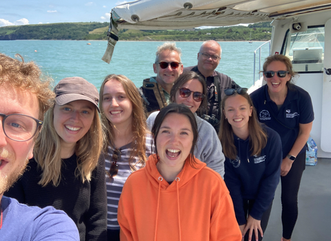 A group selfie on a boat in summer.